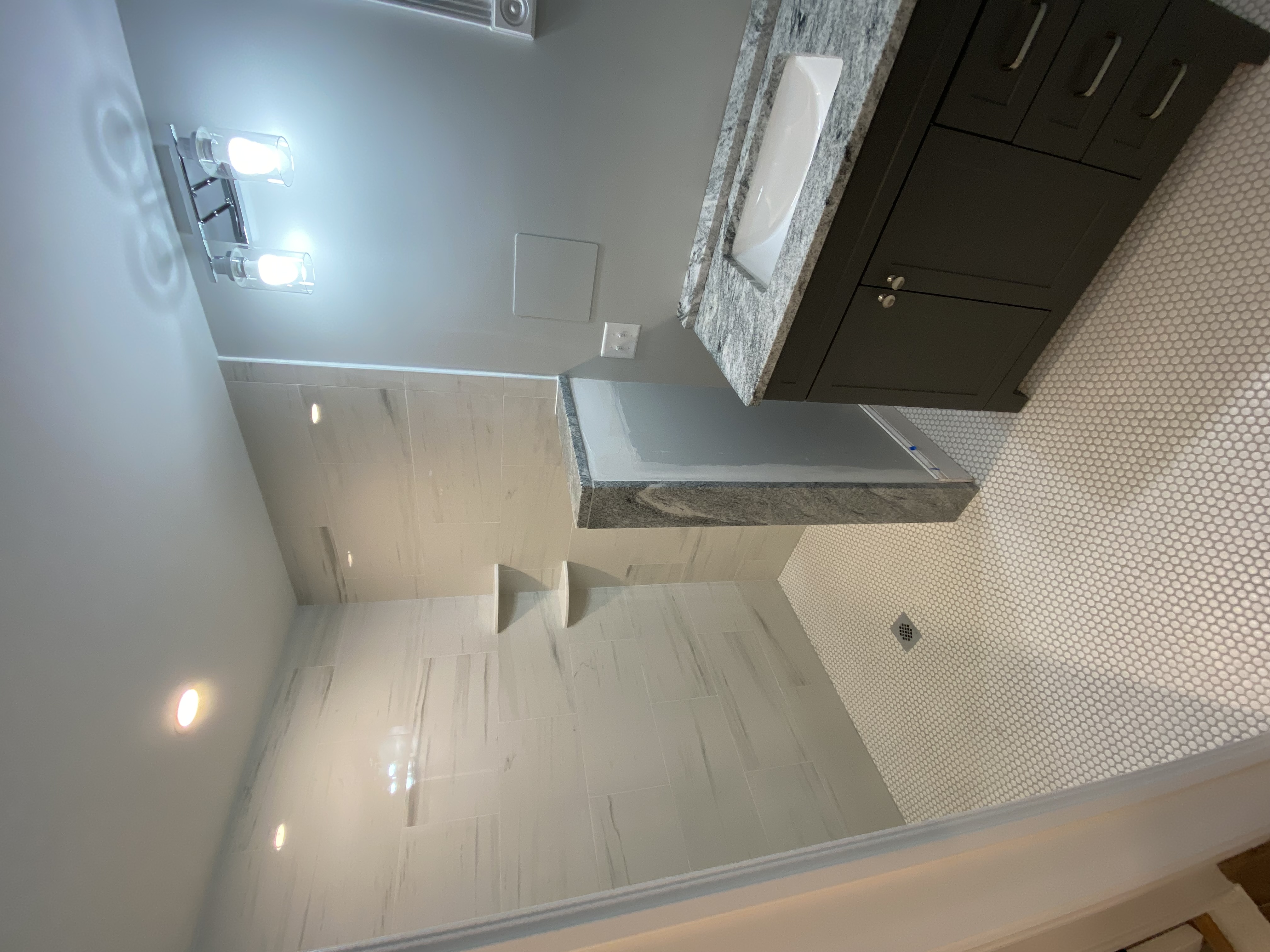 Bathroom remodel with granite vanity and penny tile